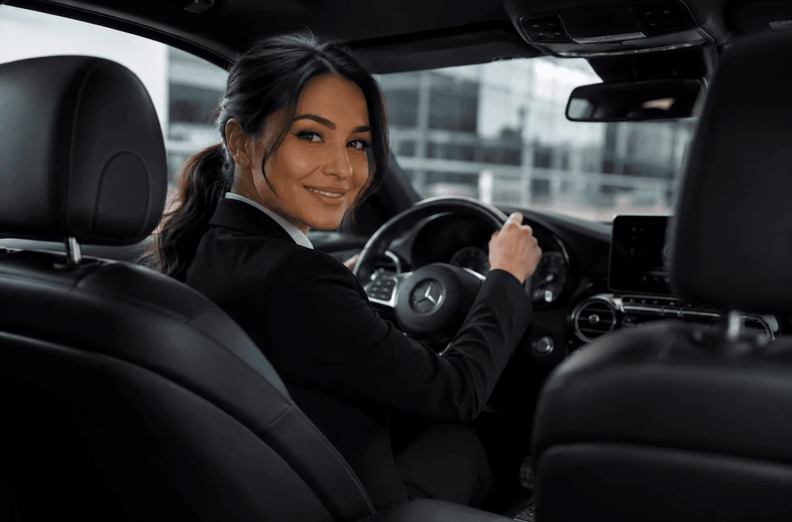 Female private chauffeur at the wheel of a Mercedes in Helsinki