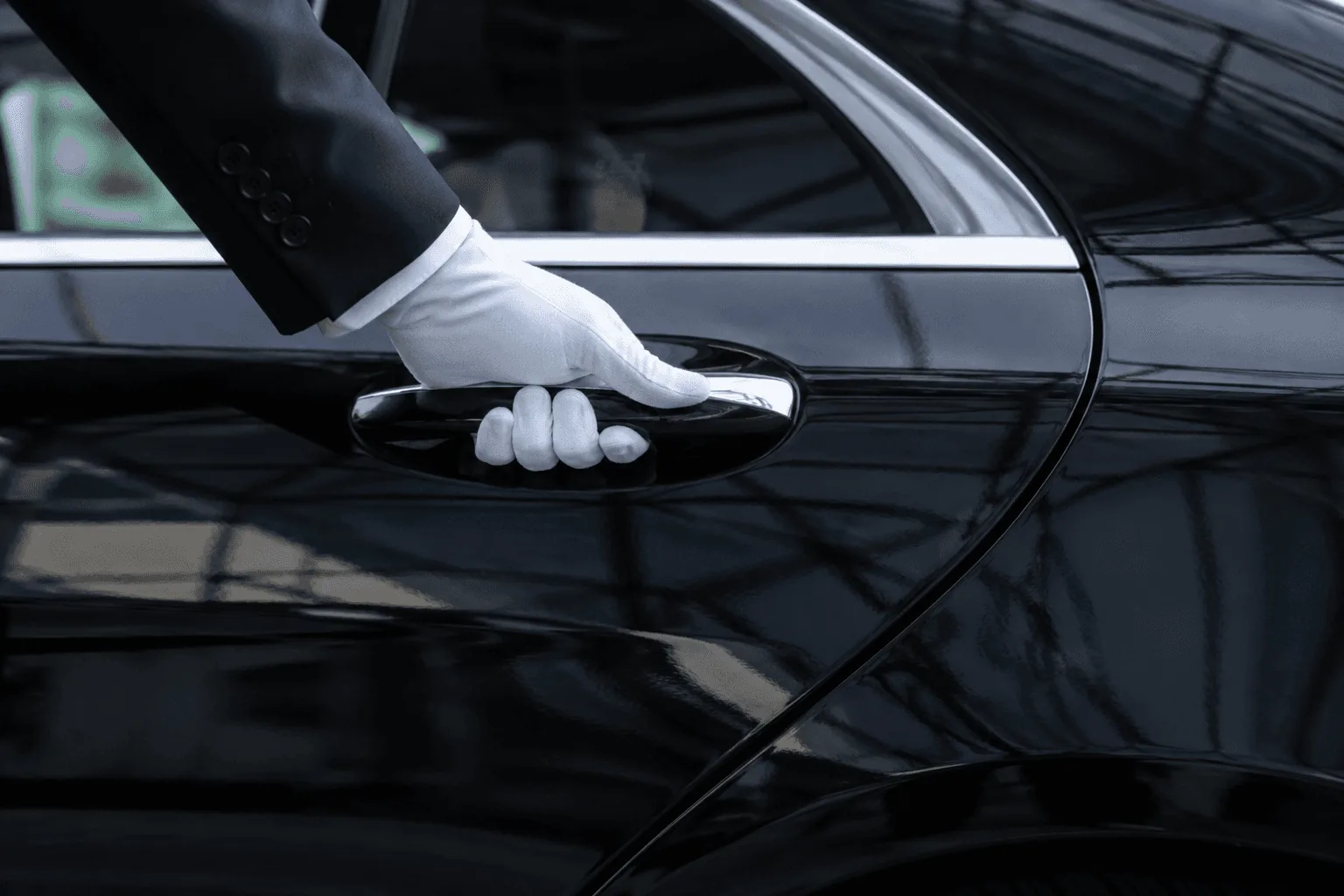 White-gloved chauffeur opening the door of a black Mercedes for a VIP airport transfer in Helsinki