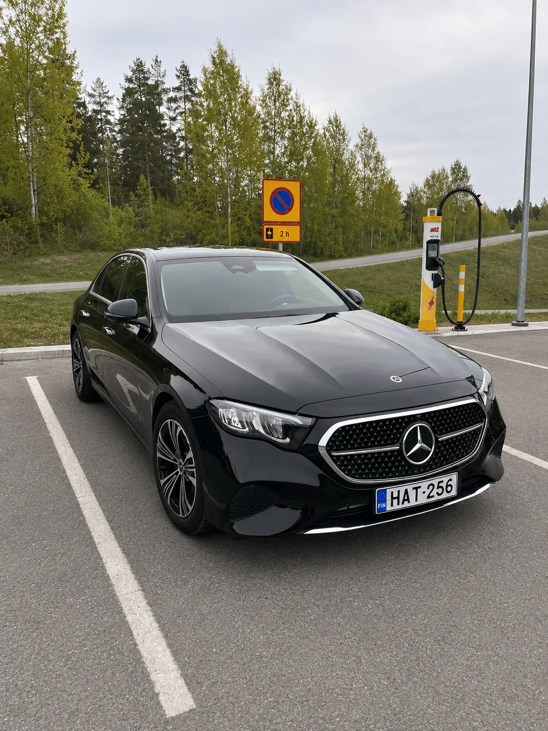 Mercedes-Benz E-Class business sedan — front angle, forest parking · Helsinki Airport Taxi